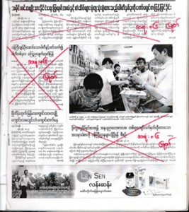 The scanned image of a front page from a Burmese newspaper shows a censor's edits in red. (source: wikimedia commons)