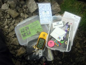 The contents of the geocache at Buckden Rake. Source: Wikipedia Commons, labelled for reuse.
